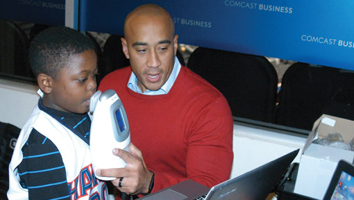 Photo of a doctor testing a young boy for asthma at a screening event at a public sporting event
