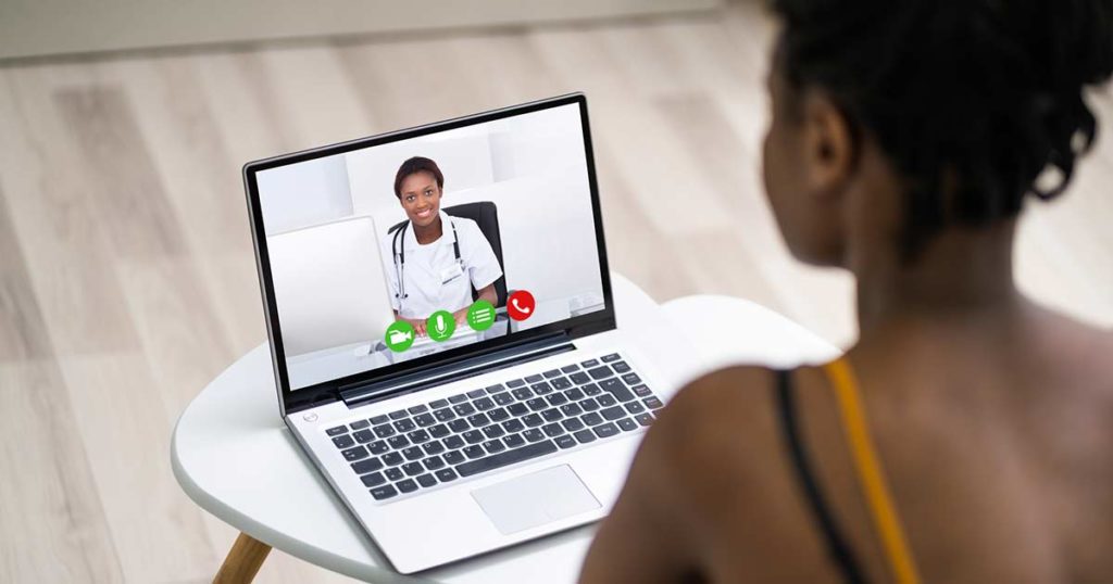 Two Black women doing a video call. One is an asthma coach professional and she is showing the other woman how to manager her asthma.