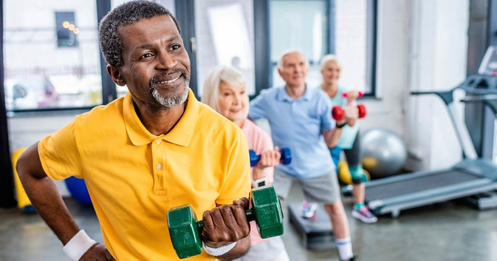 Various seniors in a gym exercising